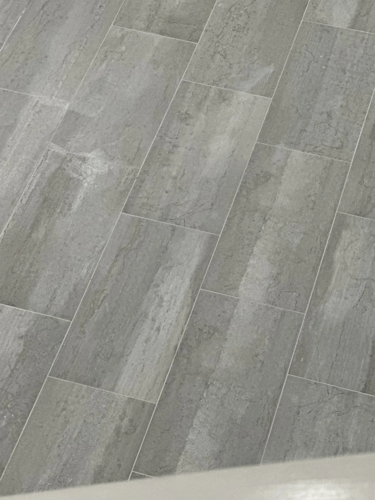 Porcelanato gris tipo piedra en formato tablón con juntas finas