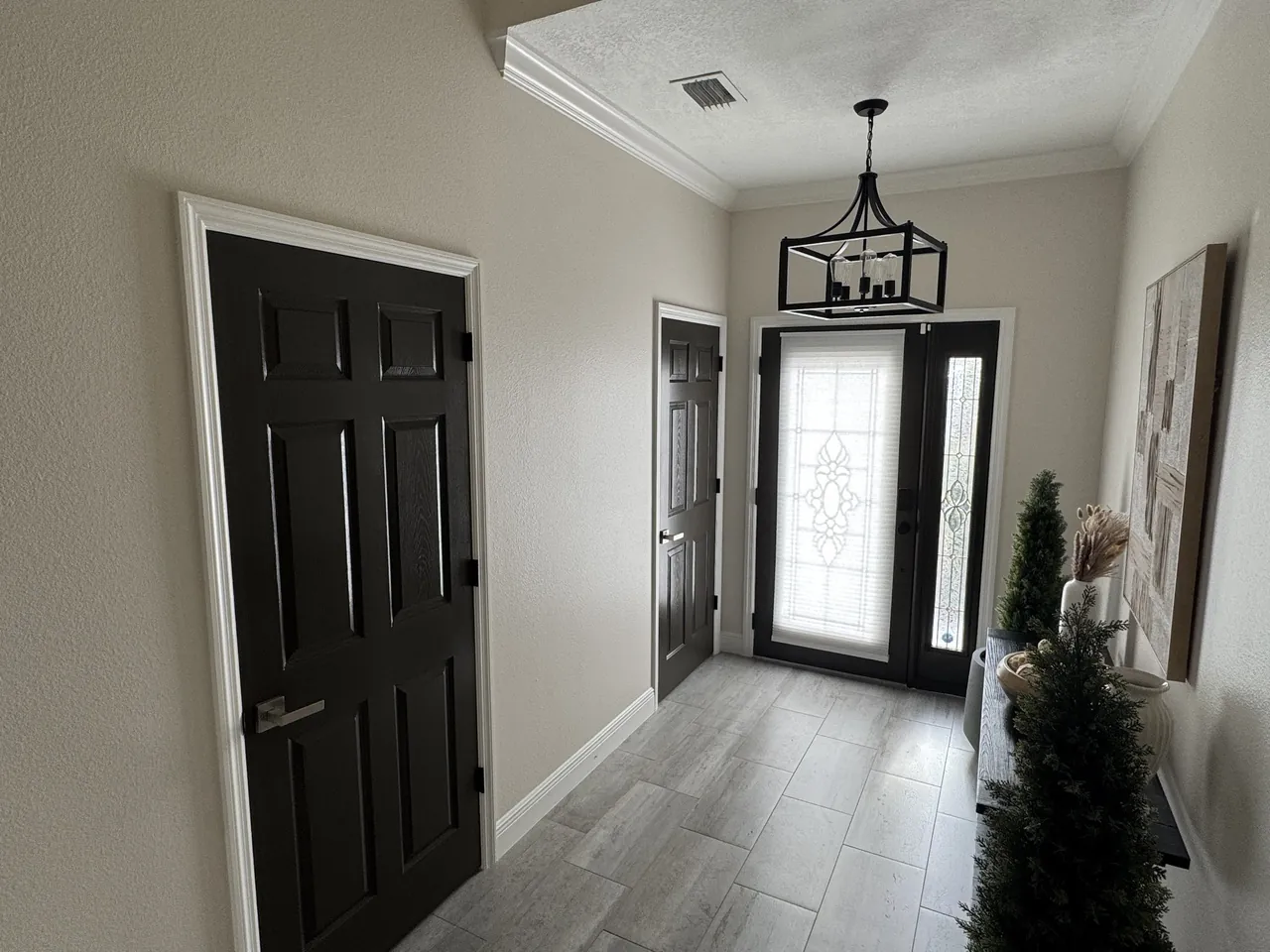 After: the same doors painted black with white trim