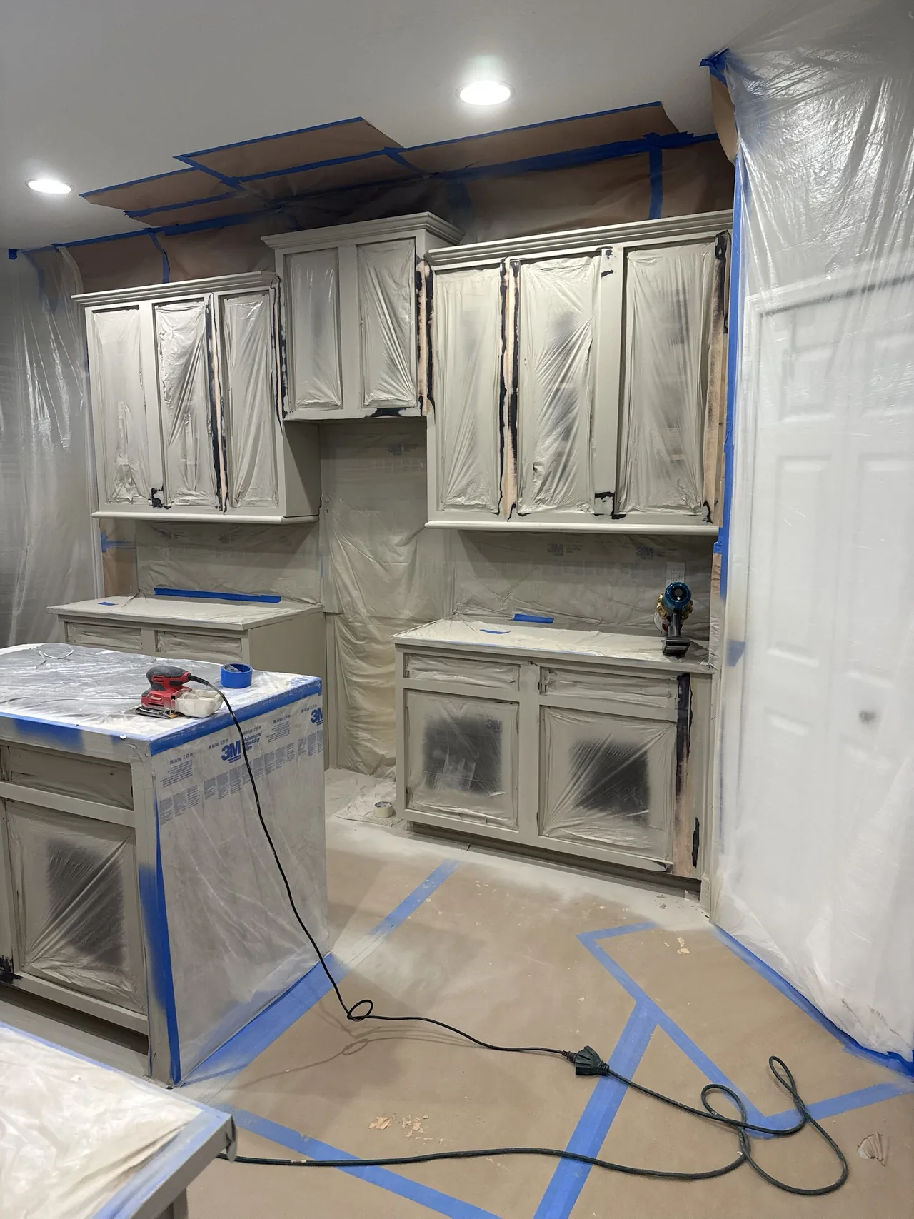 Another angle of the masked kitchen with paper on the floor