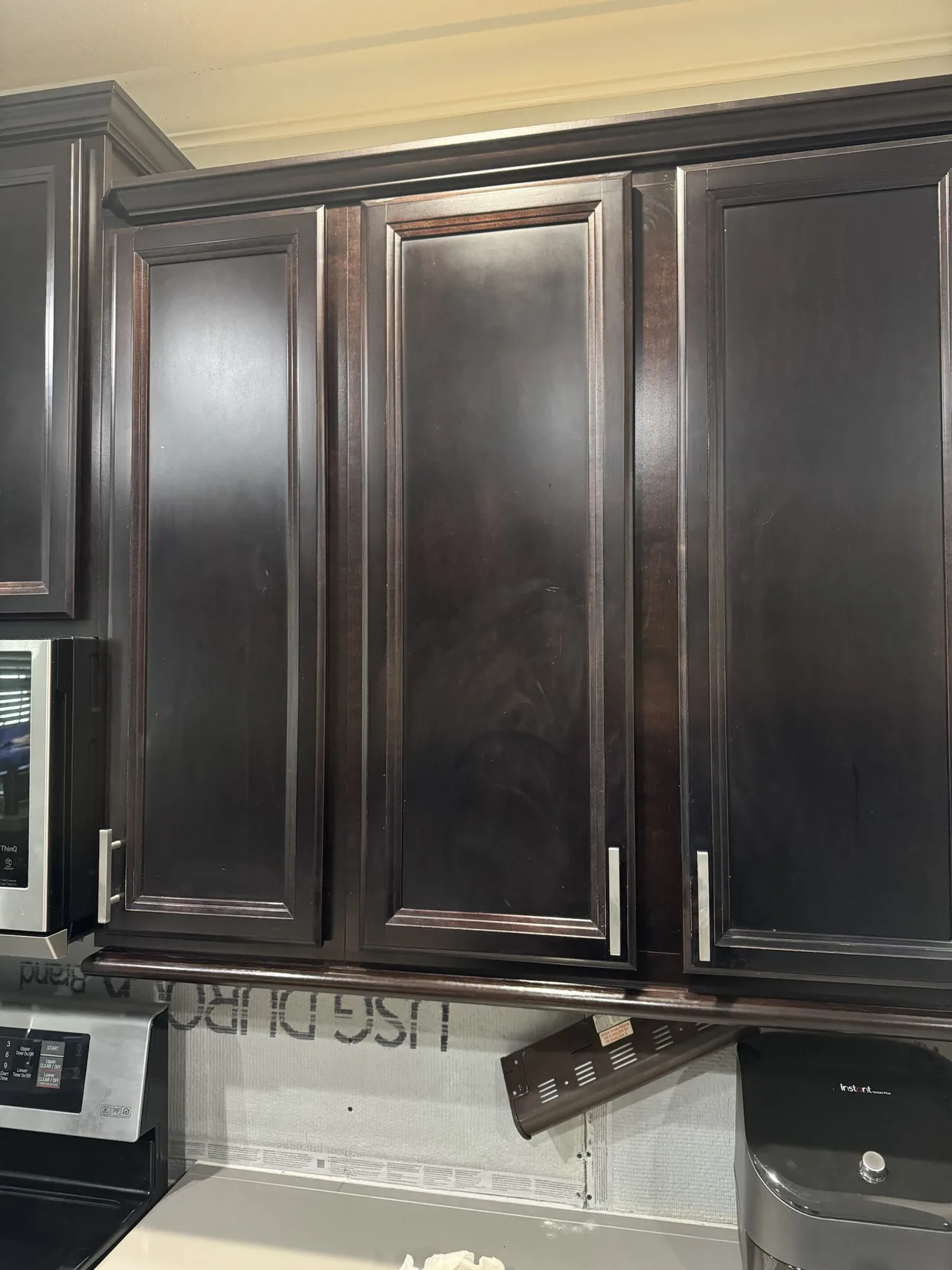 The espresso upper cabinets before painting