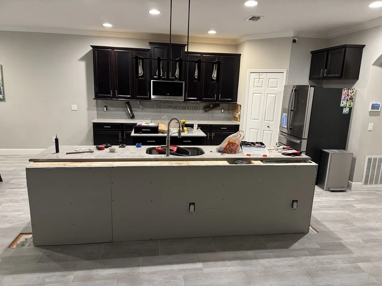 The rebuilt knee wall with new drywall, at a single counter height
