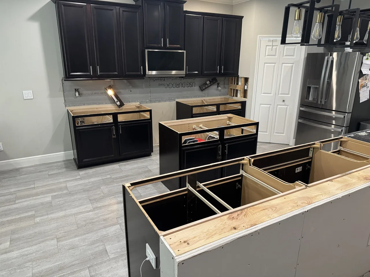 Counters removed from the perimeter cabinets and island, cement board on the backsplash wall