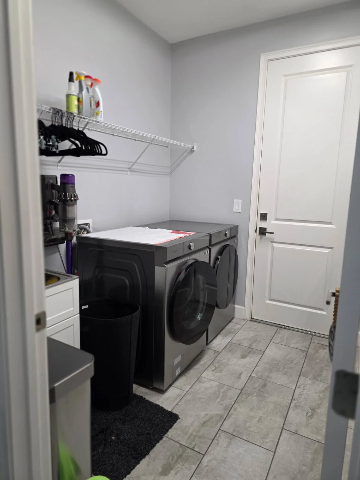 Before: a laundry room with a wire shelf and a small freestanding sink